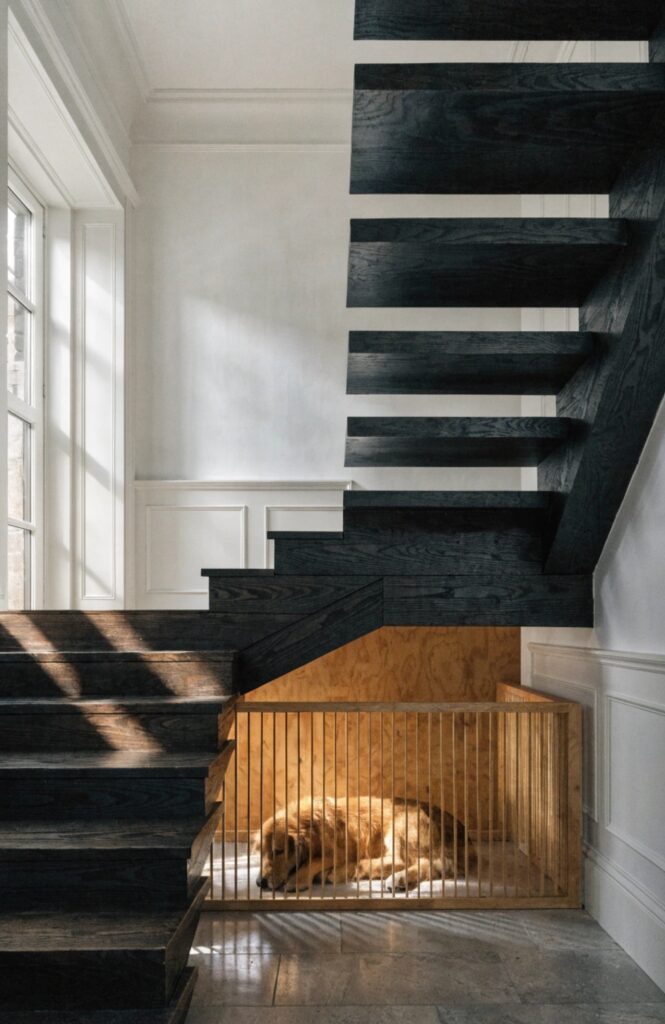 dog kennel under open riser staircase with slats
