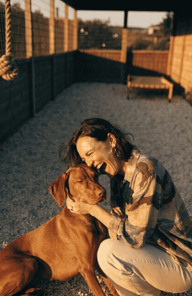 woman and dog inside a well-designed backyard dog run