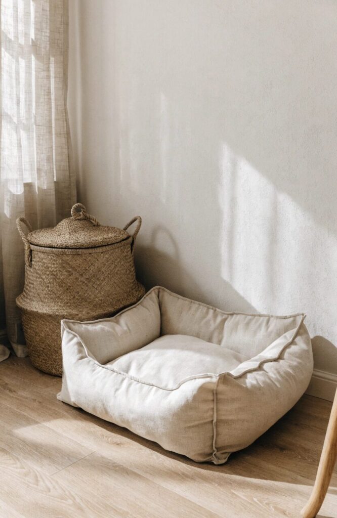 minimalist dog corner with bolstered bed and lidded woven toy basket