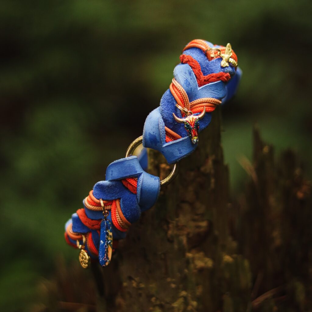 Boho braided suede leather dog collar in blue and orange paracord with gold hummingbird and butterfly charms