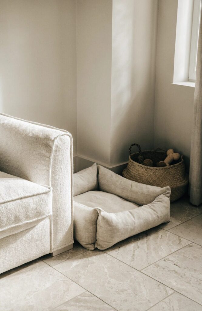 cozy dog corner with neutral bed and woven toy basket in living room