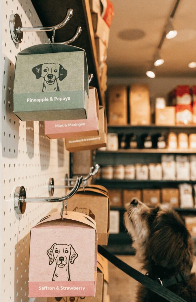 retail pillow boxes with hang tabs on display hook in a pet boutique store