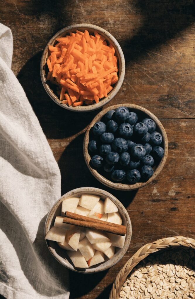 Styled ingredient swaps for homemade oatmeal dog treats on a wooden table