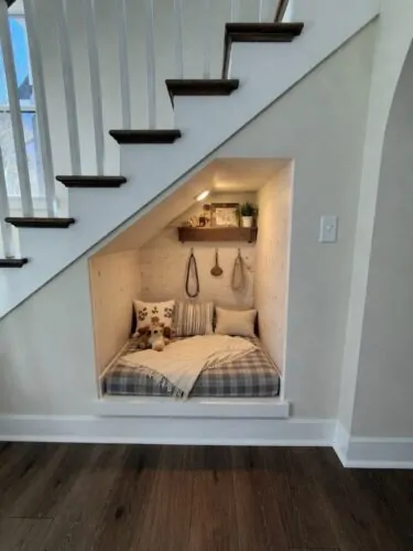 farmhouse under stair dog nook with shiplap walls LED lighting and floating shelf