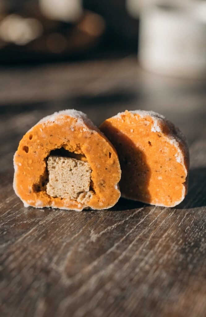Finished stuffed pumpkin yogurt dog treat cut open showing center surprise