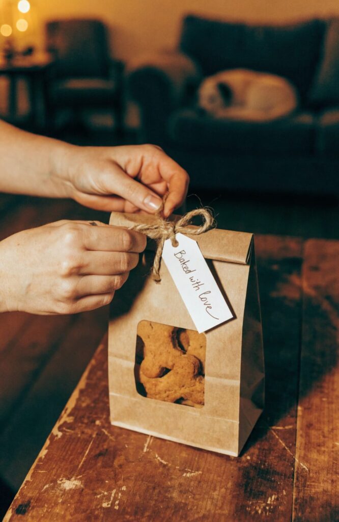 homemade dog treat kraft bag gift tied with jute ribbon on wooden table