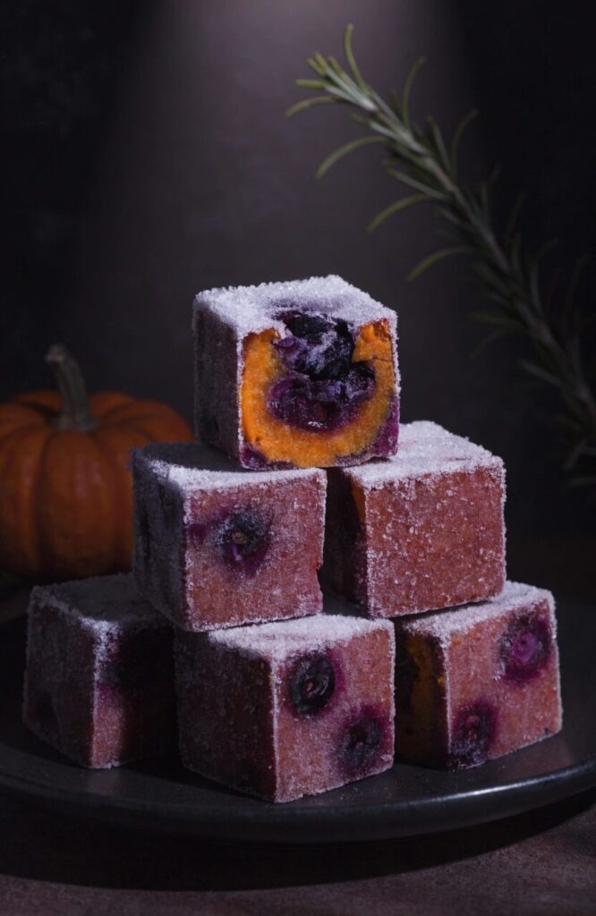 blueberry pumpkin yogurt frozen cubes for dogs stacked on dark background
