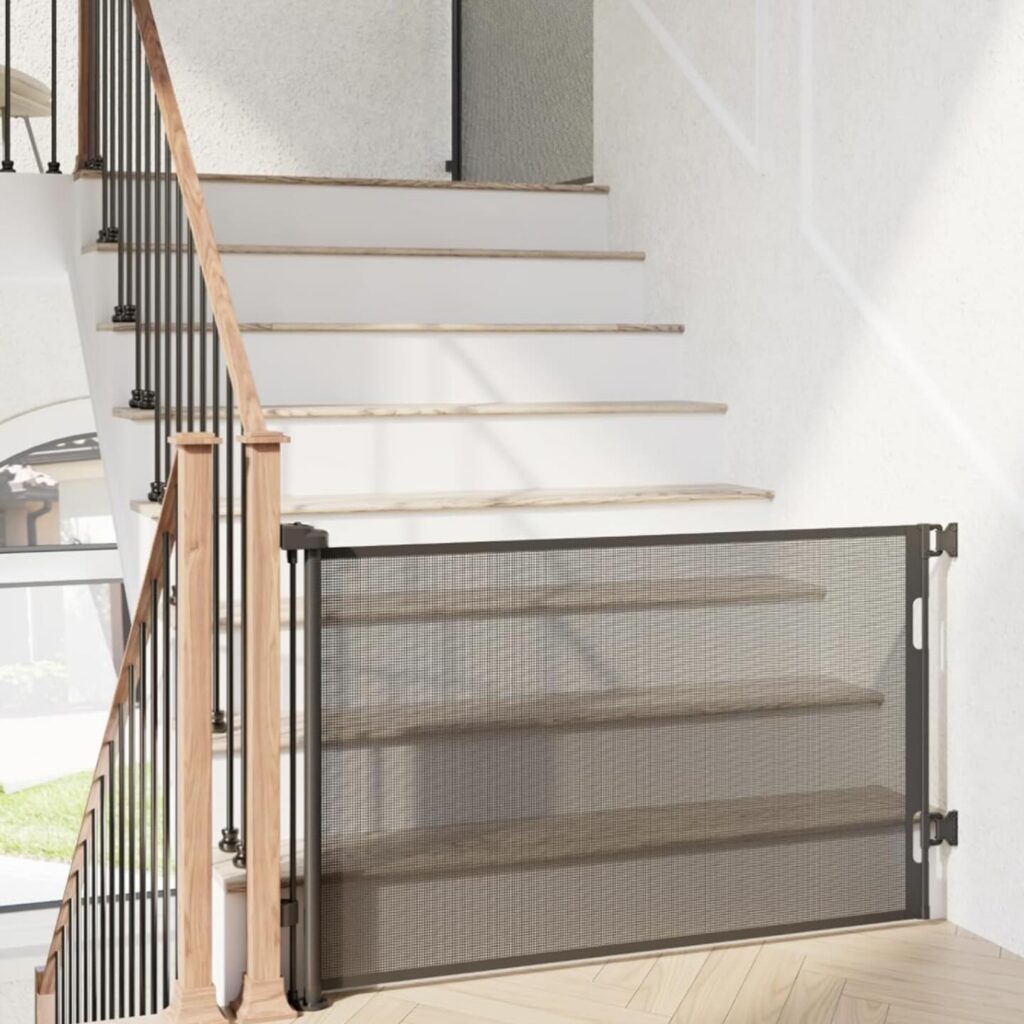 retractable mesh dog gate installed at top of staircase