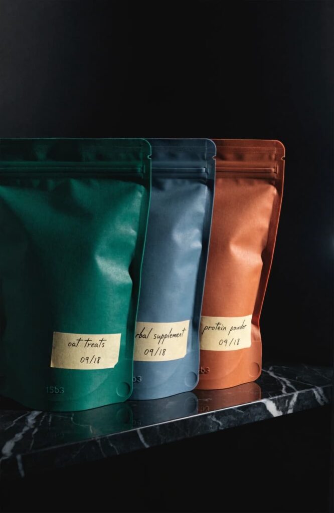 silicone reusable dog treat pouches on dark surface in minimal product photography