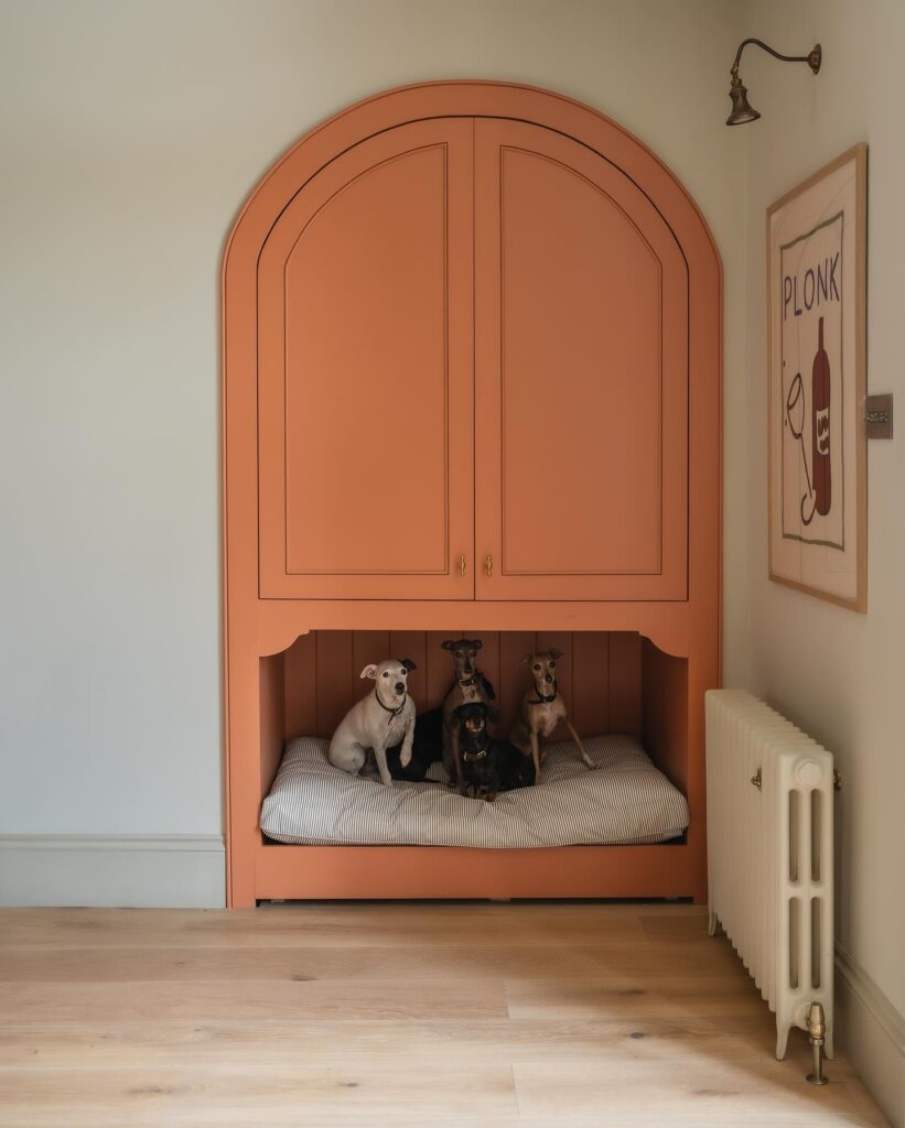 statement terracotta arched built-in cabinet with integrated dog sleeping bay for multiple dogs