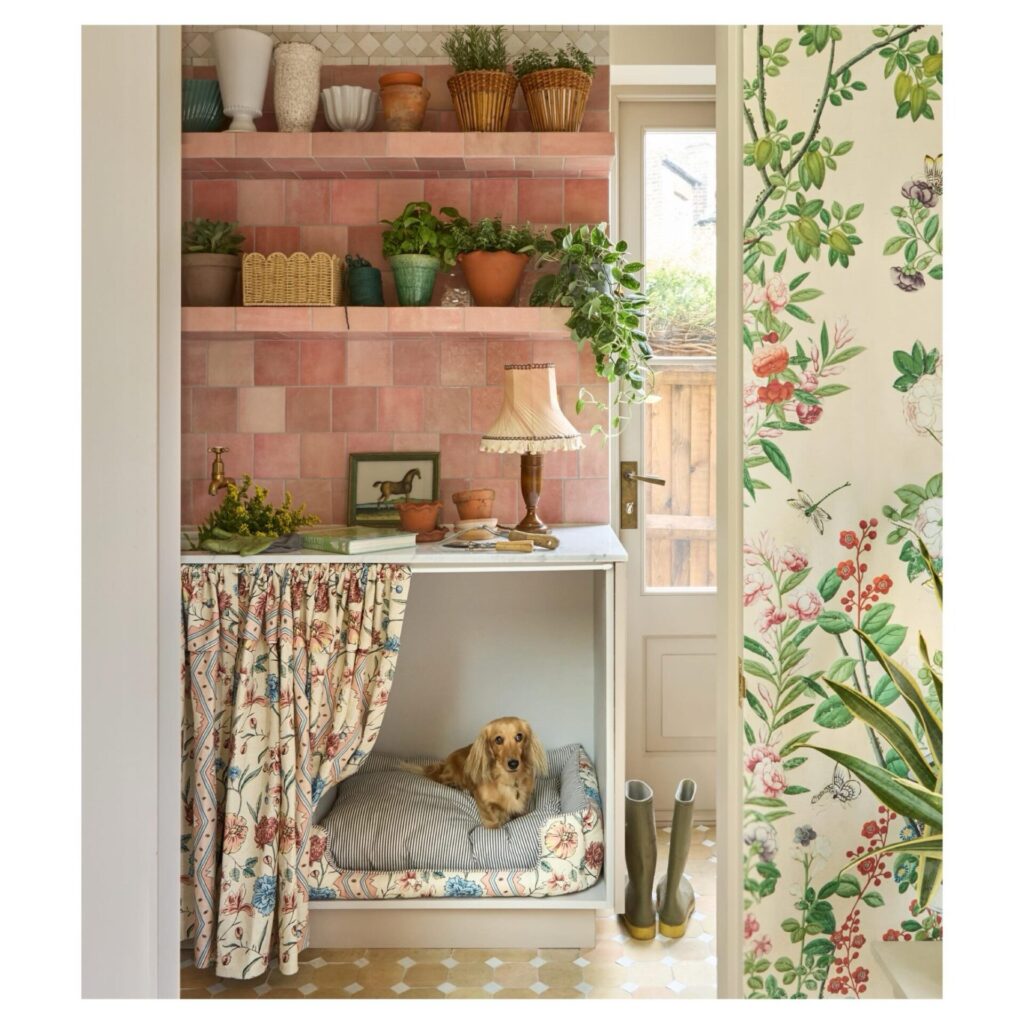 under counter dog nook with vintage floral curtain privacy screen in utility room
