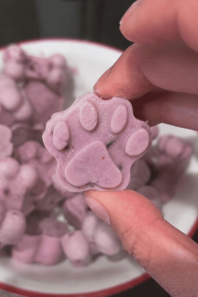 Purple blueberry banana paw and bone shaped no bake dog treats with berry specks