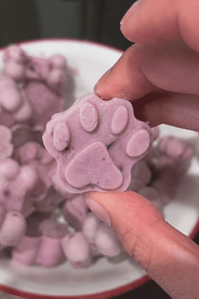 Purple blueberry banana paw and bone shaped no bake dog treats with berry specks