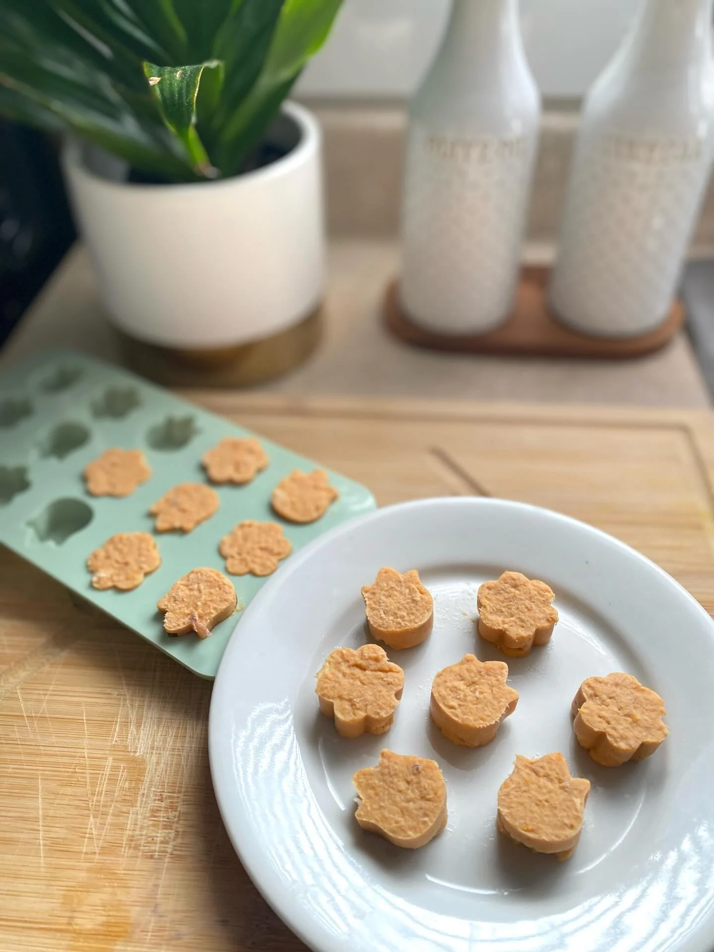 Pale orange chicken and sweet potato bites in flower and chick shaped molds