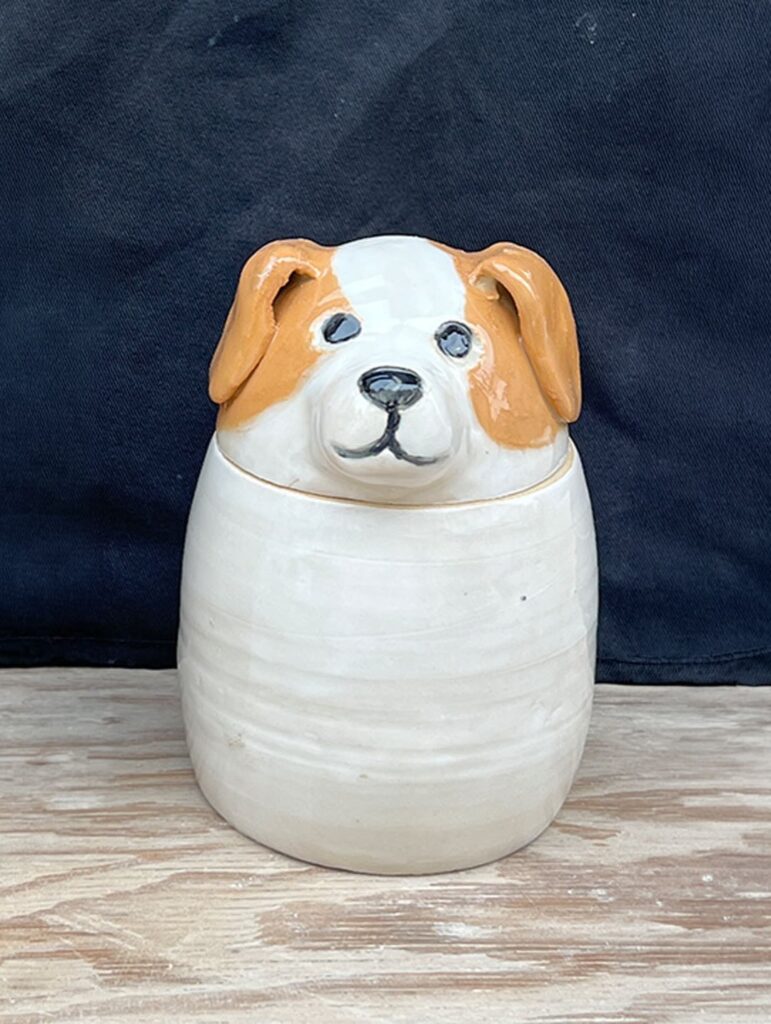 Sculptural 3D dog head lid on white ceramic treat jar