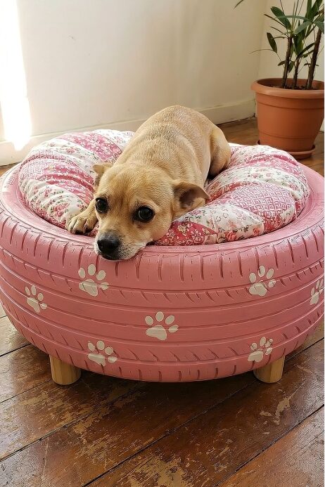 Upcycled tire raised dog bed idea painted pink with paw prints