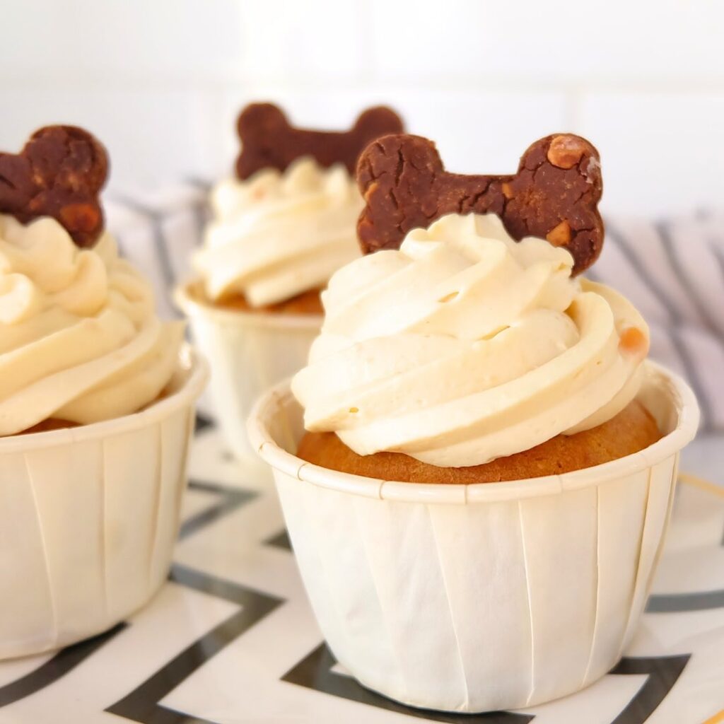 Classic peanut butter pupcake with cream frosting and biscuit topper