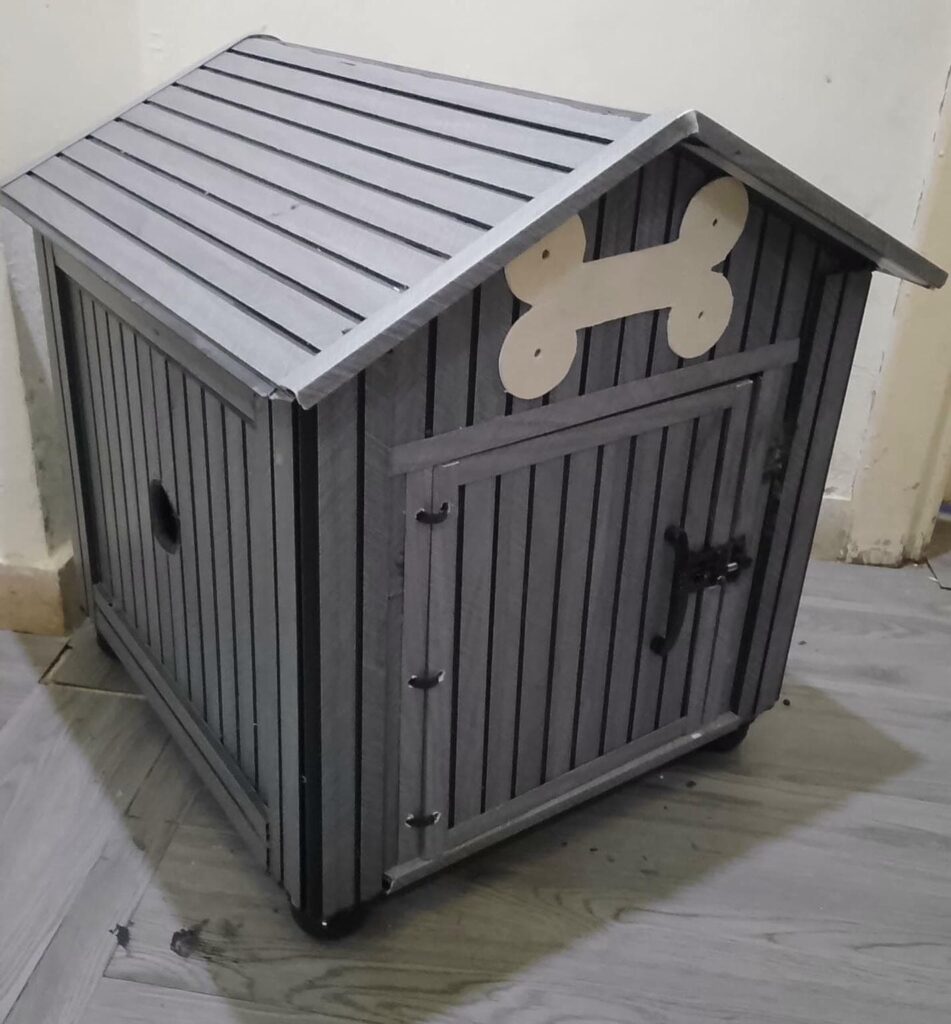 Grey slatted wooden dog house with bone cutout decoration