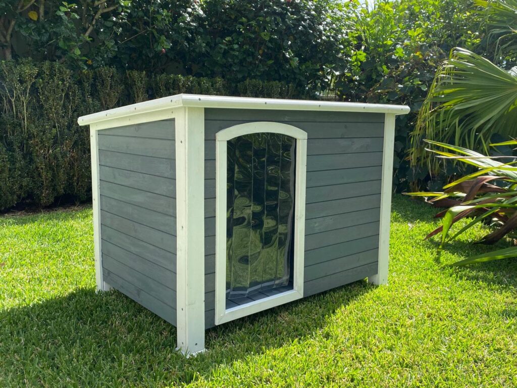 Weatherproof wooden dog house with PVC strip door