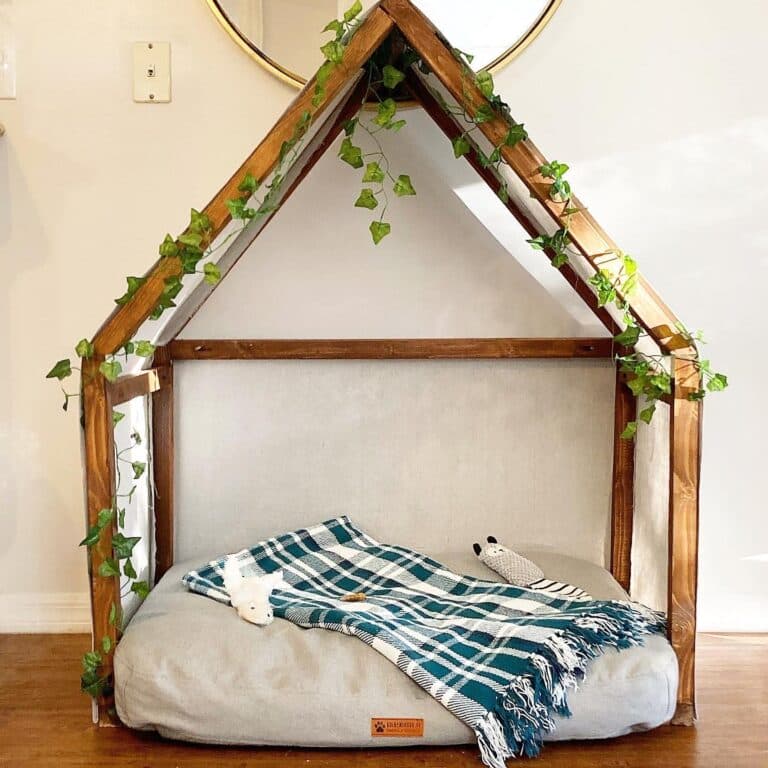 Boho style open frame wooden dog house bed with greenery