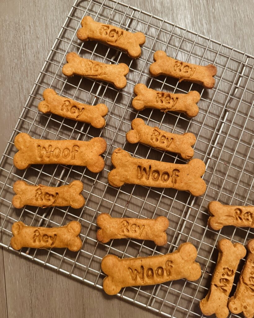 Homemade 3-ingredient dog treats shaped like bones with names stamped on