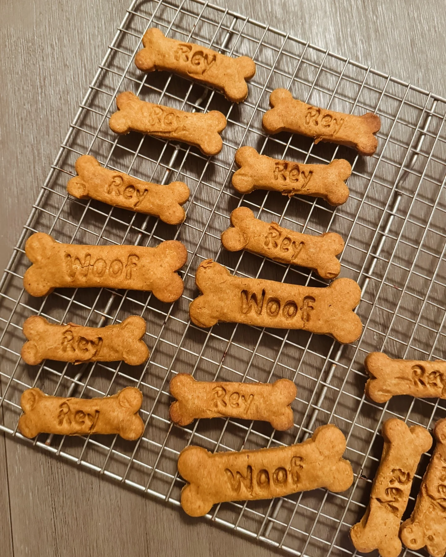Homemade 3-ingredient dog treats shaped like bones with names stamped on