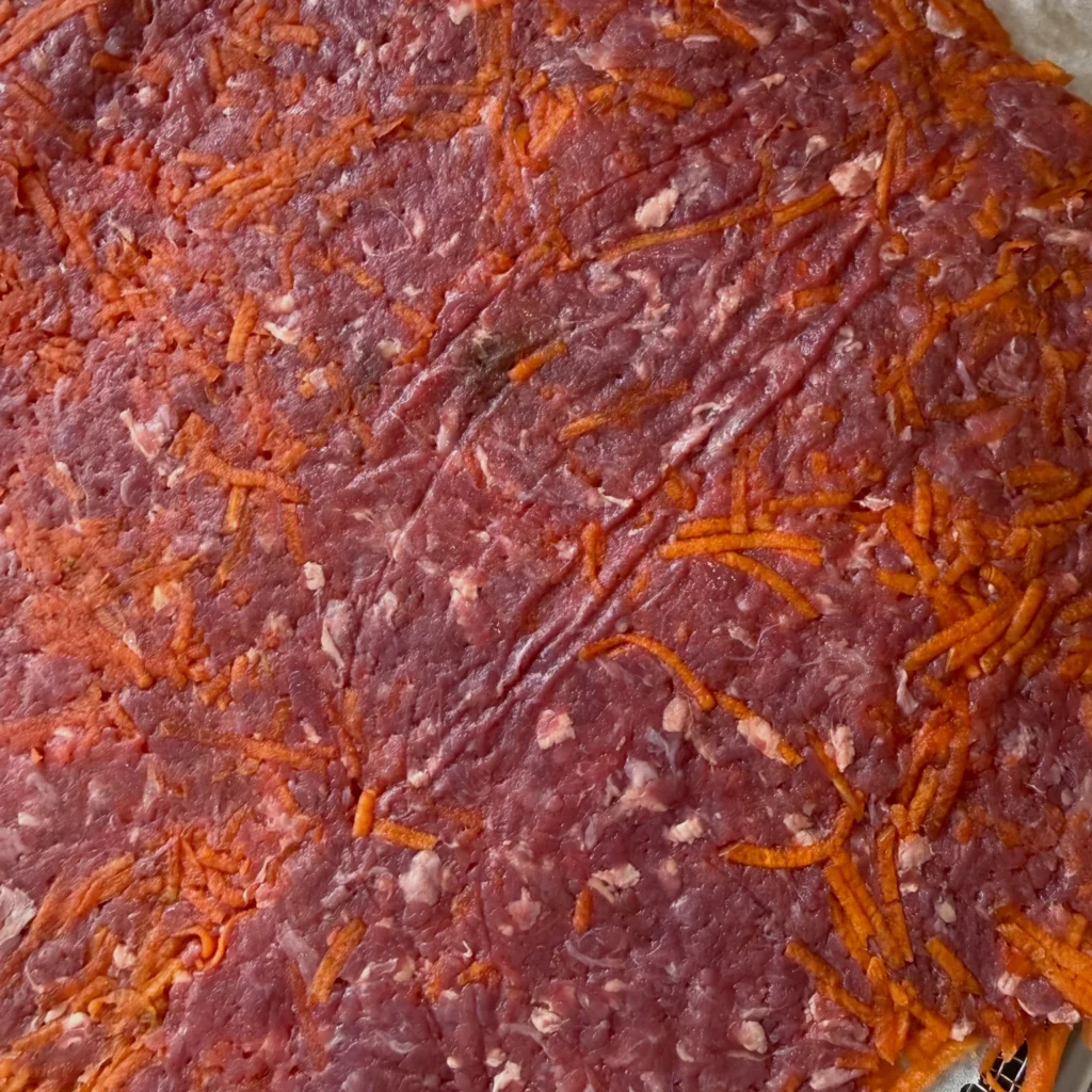 Raw beef and grated carrot mixture for dental chew treats