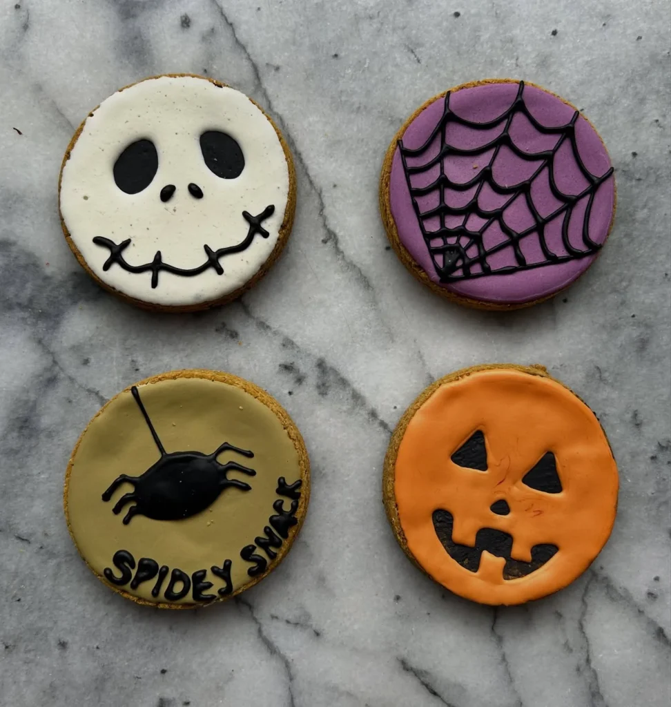 Decorated Halloween character dog cookies with spider web