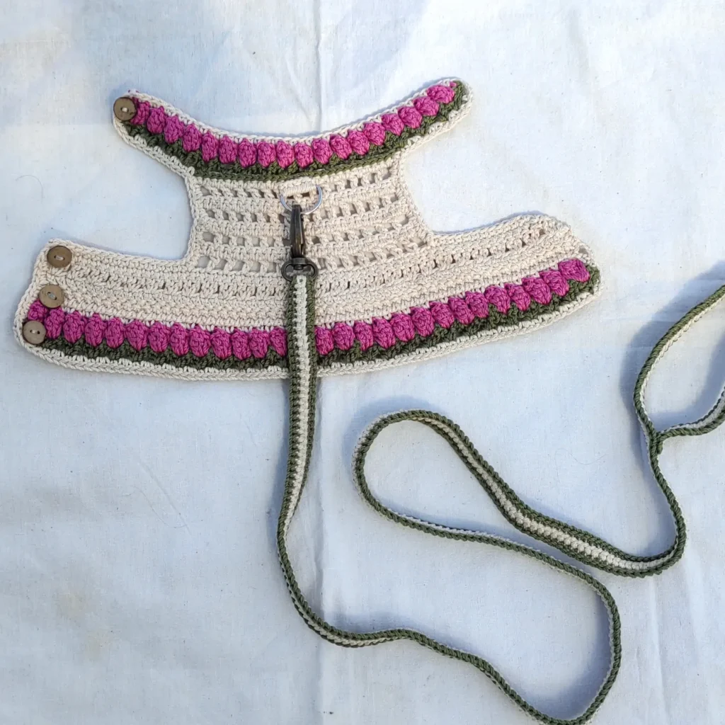 Ivory tulip bobble stitch crochet dog harness pattern with button closure
