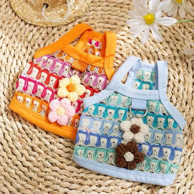 Lace look crochet vest harness for dogs with floral appliques in orange and blue