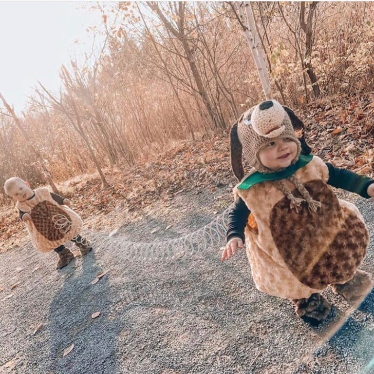 Twin toddlers wearing DIY Slinky dog costume with coil