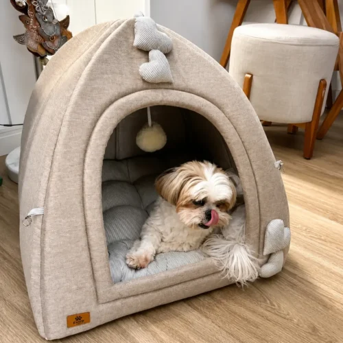 Beige fabric igloo dog tent with heart shaped pillows