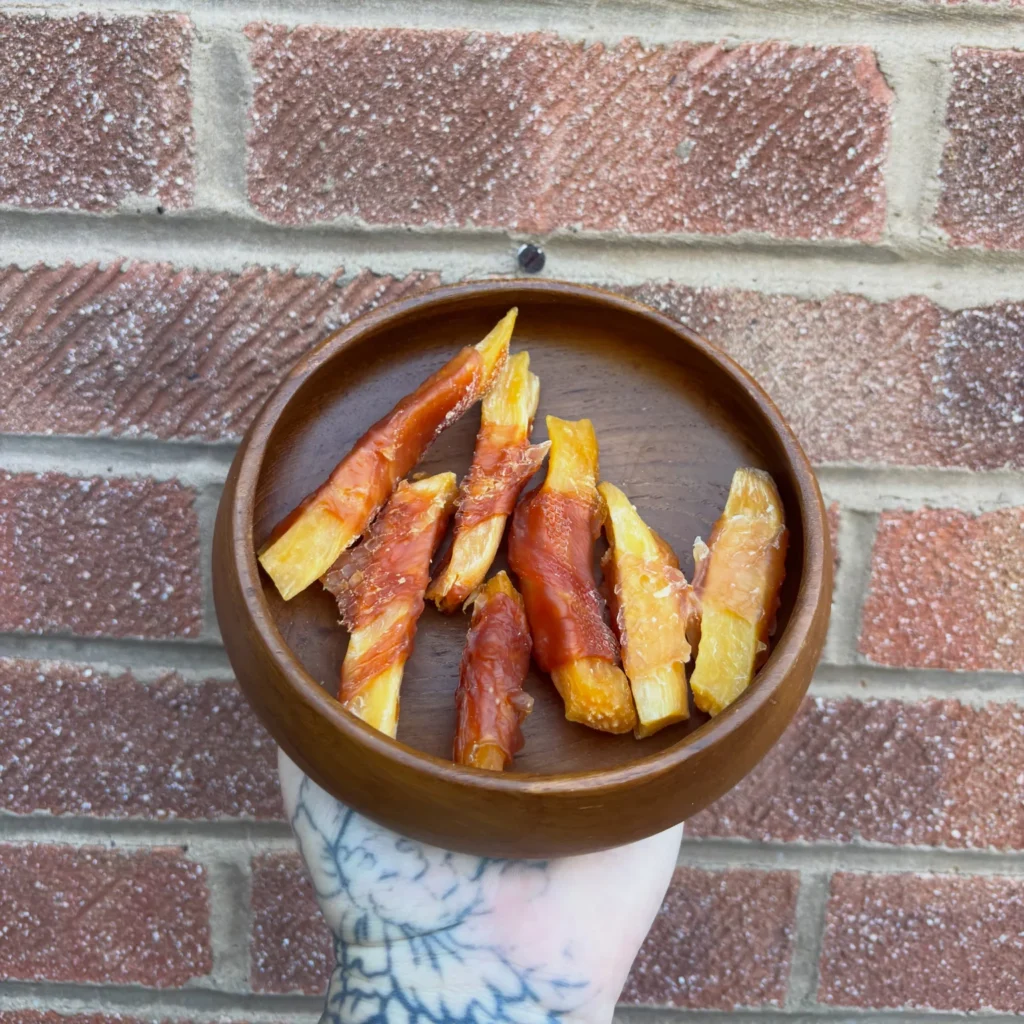 Chicken wrapped sweet potato dog chews in a bowl