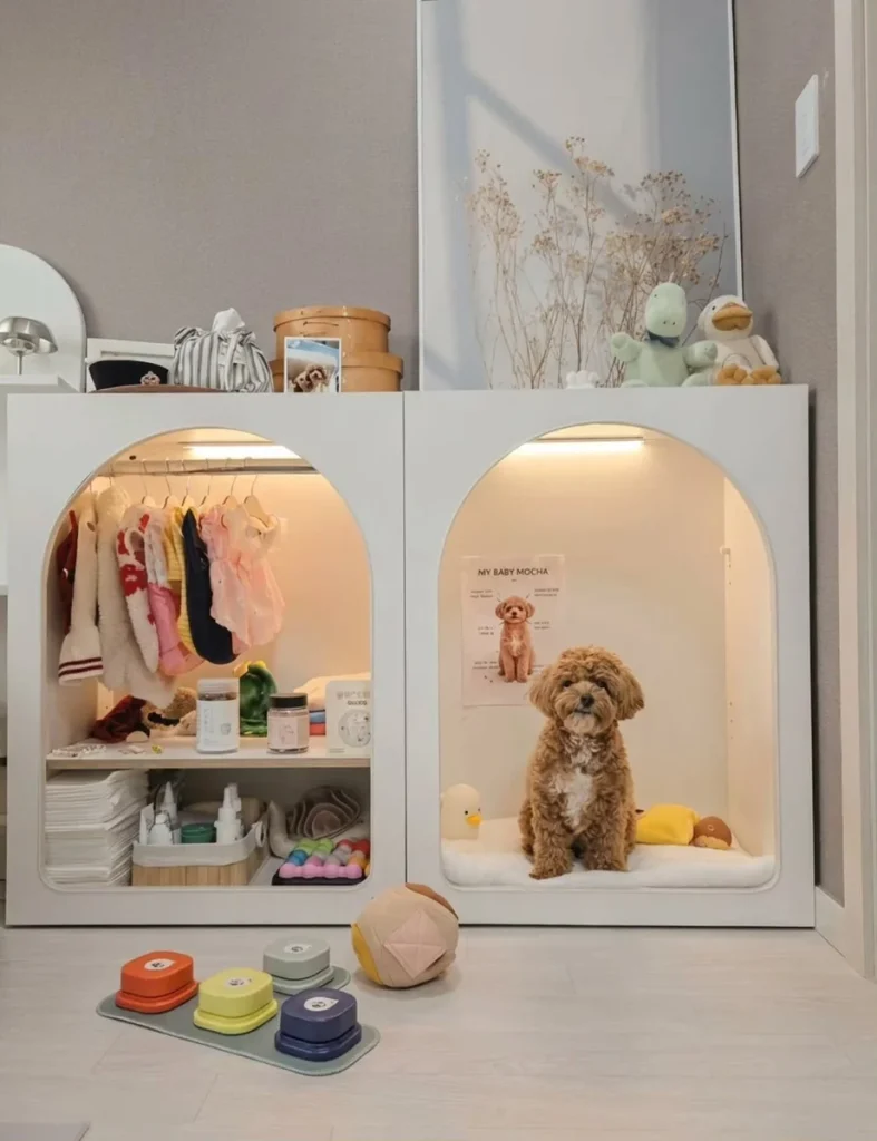 White arched cabinet with built in closet and lit dog bed nook