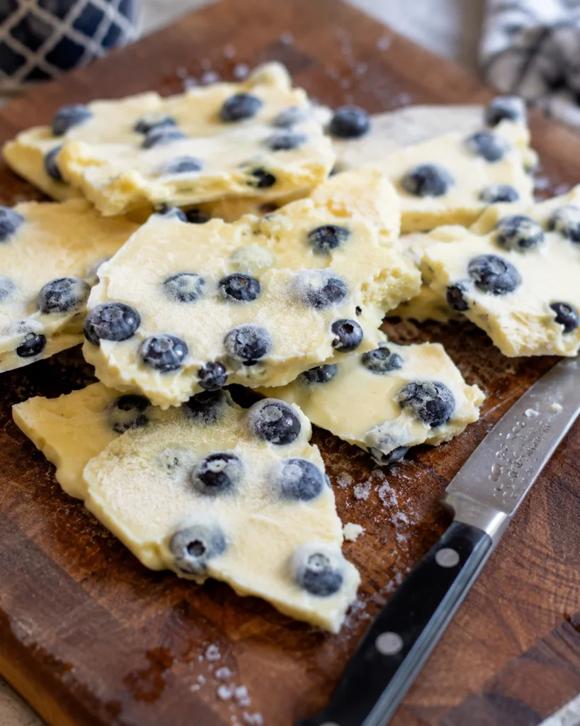 Frozen anti-inflammatory yogurt bark dog treats on a wooden board