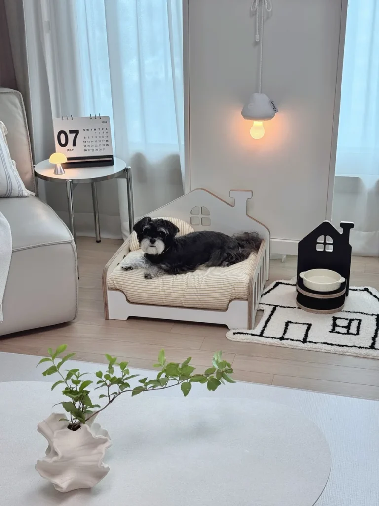 White house shaped dog bed with matching house shaped bowl stand