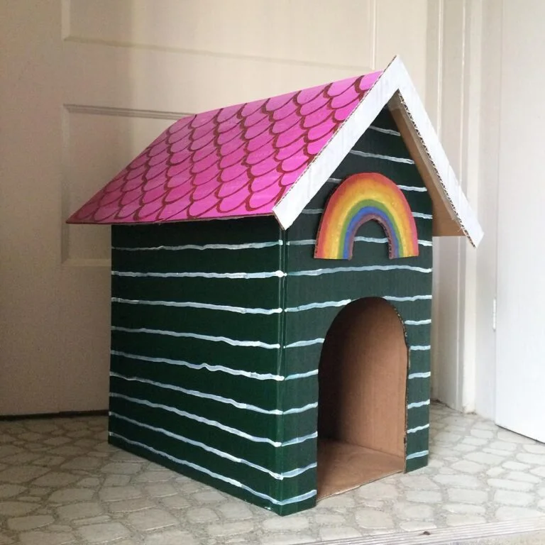 Painted cardboard dog house idea with pink scale roof design