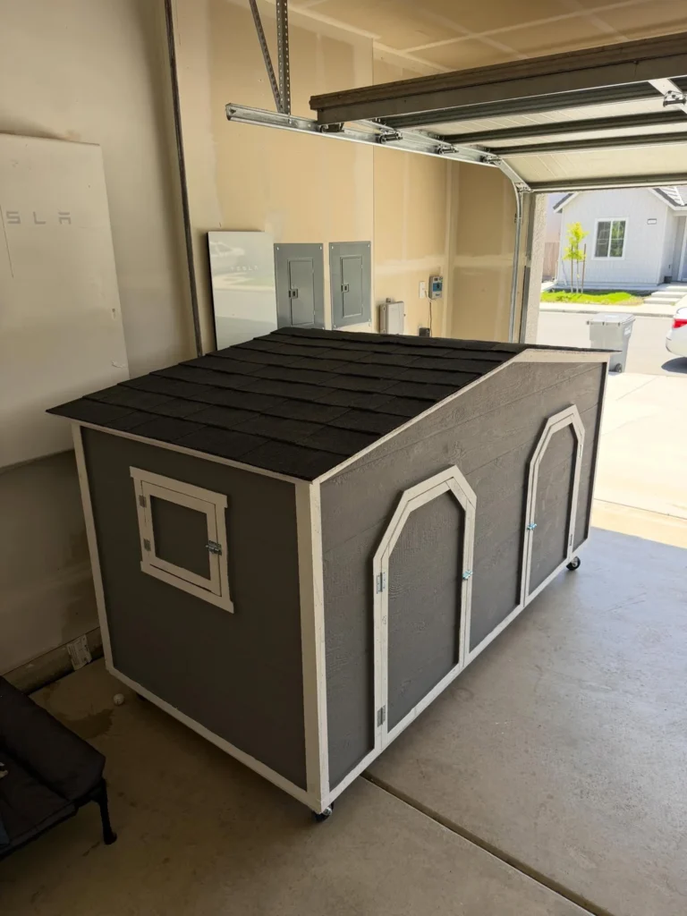 Portable double dog house on wheels, side angle view