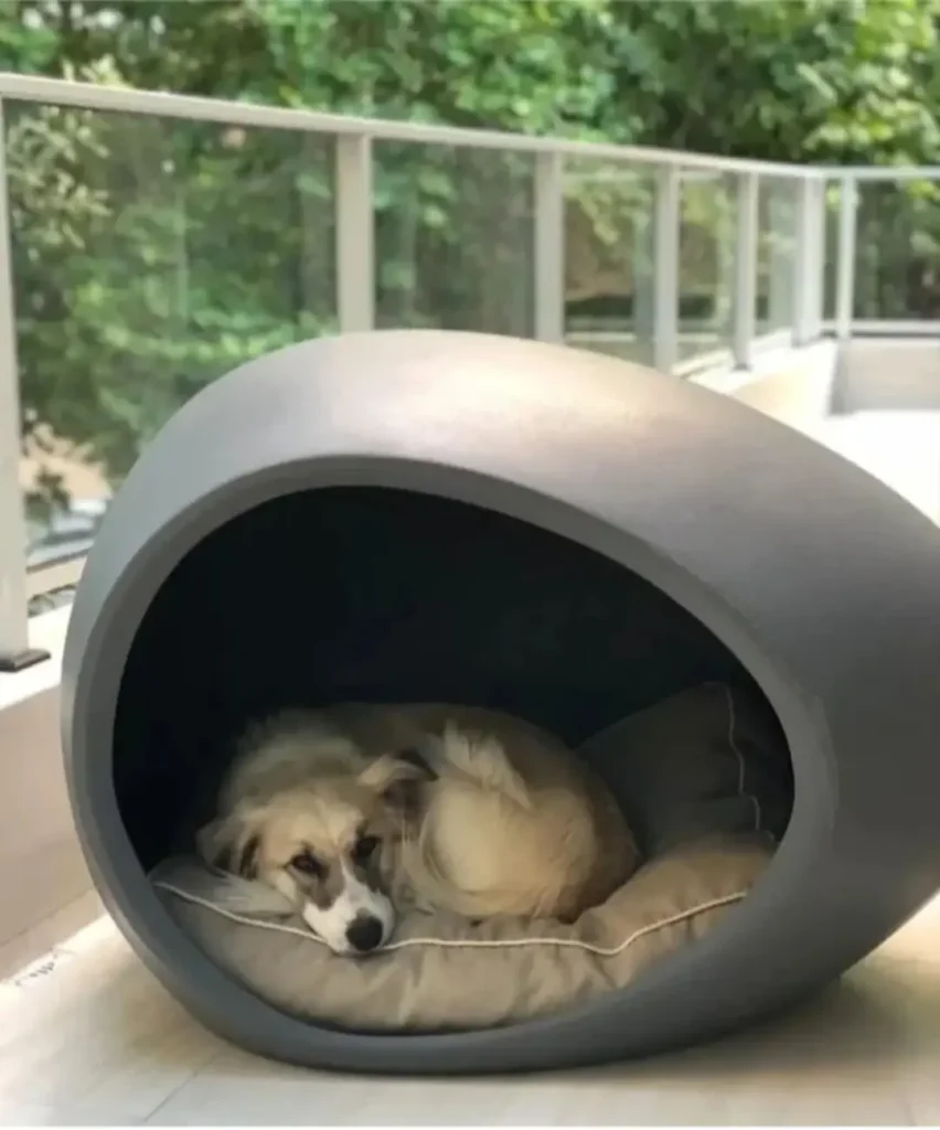 Sculptural stone egg shaped outdoor dog house