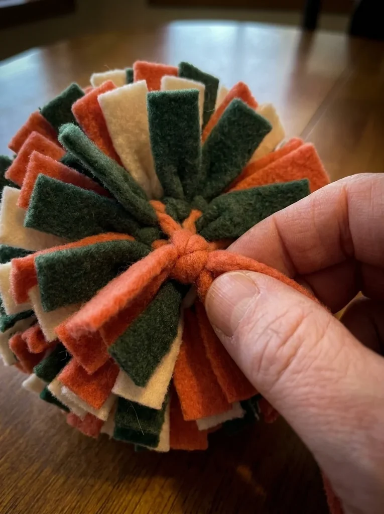 Tying fleece knots while assembling a homemade dog toy